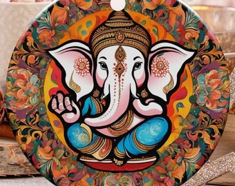 May include: A round Christmas ornament featuring a colorful illustration of the Hindu deity Ganesha. The ornament has a gold string for hanging and is surrounded by festive decorations, including candy canes and a star-shaped ornament.