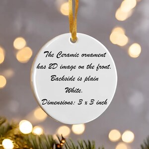 May include: A white ceramic ornament with a gold ribbon for hanging. The text on the front reads: "The Ceramic ornament has 2D image on the front. Backside is plain White. Dimensions: 3 x 3 inch."