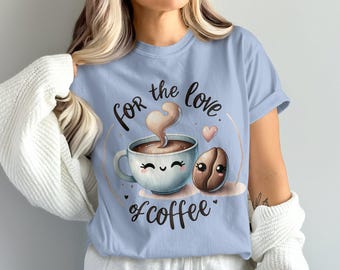 May include: Light blue t-shirt with a coffee-themed graphic. The design features a smiling coffee cup, a coffee bean, and the text "for the love of coffee." The steam from the coffee cup is shaped like a heart.