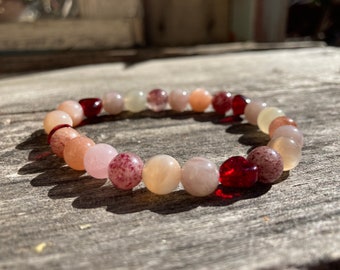 Heart on Your Sleeve Reiki-Blessed Bracelet: Strawberry Quartz, Madagascar Rose Quartz, Moonstone, Red Glass Hearts