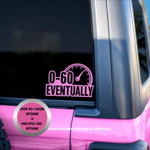 May include: Pink car window decal with the text "0-60 EVENTUALLY" and a speedometer graphic. The decal is on a pink vehicle. Additional text reads "OVER 40+ COLOR OPTIONS & MULTIPLE SIZE OPTIONS".