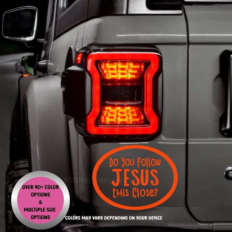 May include: A gray vehicle with a bright red taillight. An orange oval sticker on the vehicle reads "Do you follow JESUS this Close?" with additional text about color and size options.