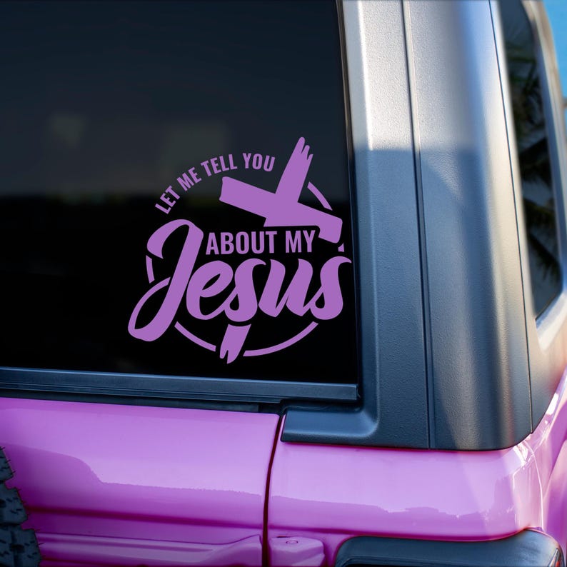 May include: A pink vinyl decal with a cross and the text "Let me tell you about my Jesus" on a black background.