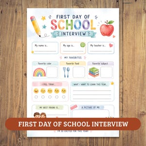 Puede incluir: Una hoja de papel blanca titulada First Day of School Interview con coloridas ilustraciones en acuarela que incluyen un lápiz amarillo, una manzana roja, un arcoíris, libros y cubiertos. Contiene líneas y casillas en blanco para rellenar.