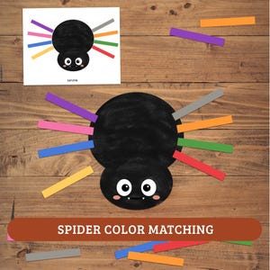 May include: A spider color matching activity featuring a large black spider cutout with white eyes and pink cheeks. Eight colorful paper strips in gray, orange, green, red, yellow, blue, pink, and purple are included for matching to the spider legs.