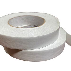 May include: Two rolls of white double-sided adhesive tape.