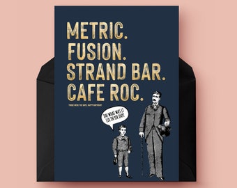May include: A navy blue card with gold lettering that reads "Metric. Fusion. Strand Bar. Cafe Roc."  The card features a black and white illustration of two men, one tall and one short, with a speech bubble above the shorter man that reads "Oh what was it like in the day?"