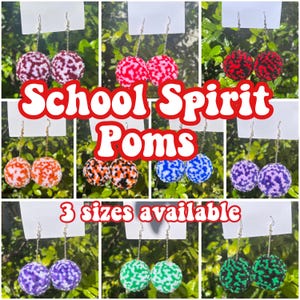 May include: A set of colorful pom-pom earrings with different patterns. The earrings are available in three sizes. The text "School Spirit Poms" is displayed in the center of the image.