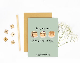 May include: A green card with the text "dad, no one stacks up to you" and a graphic of three stacks of pancakes with different toppings. The card also says "happy father's day".