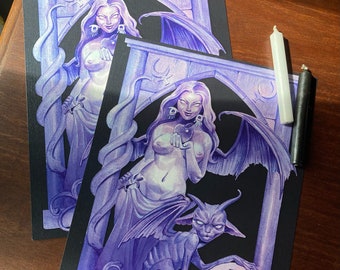 May include: Two purple and black framed illustrations of women with wings and a demon. The women are holding a sphere in their hands. The demon is holding a pentagram.