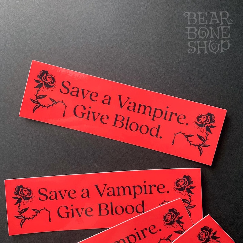 May include: Three red stickers with black text and a black rose design. The text on the stickers reads "Save a Vampire. Give Blood."