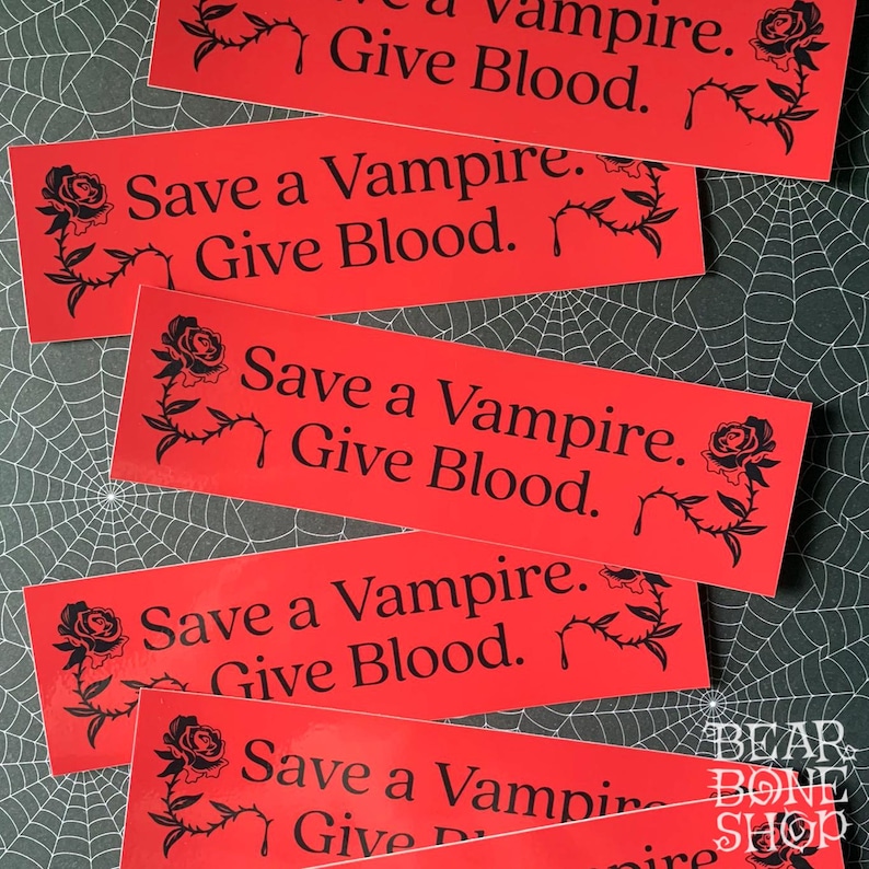 May include: Five red stickers with black text and a black rose graphic. The text on the stickers reads "Save a Vampire. Give Blood."