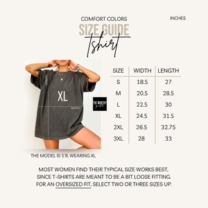 May include: A Comfort Colors size guide for a t-shirt, featuring a charcoal grey t-shirt on a model with an XL label. A table lists sizes S through 3XL with corresponding width and length measurements in inches. Text notes the model is 5'8 wearing XL.