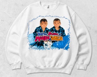 May include: A white crewneck sweatshirt featuring a graphic print of Mary-Kate and Ashley Olsen wearing blue plaid shirts. The text reads You're Invited to Mary-Kate & Ashley's with a blue splatter border and a 1999 Dualstar Entertainment Group copyright.