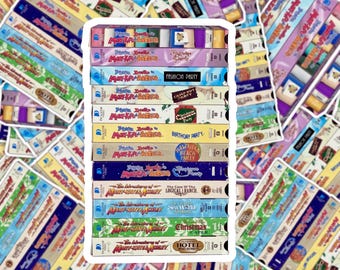 May include: A collection of vintage VHS tapes featuring titles like "Fashion Party," "Campout Party," and "Hawaiian Beach Party." The tapes have colorful labels with text and illustrations, showcasing a nostalgic aesthetic.