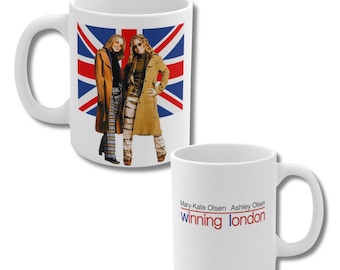 May include: White ceramic mug featuring a Union Jack flag design with two women in front. The second mug has the text "Mary-Kate Olsen Ashley Olsen Winning London" in red and blue.