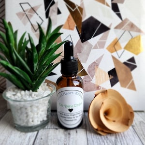 May include: A brown glass bottle with a dropper top and a white label that reads "Healed Heart Wellness Ear Ache Drops Organic Extra Virgin Olive Oil Colloidal Silver & Tea Tree Essential Oil".