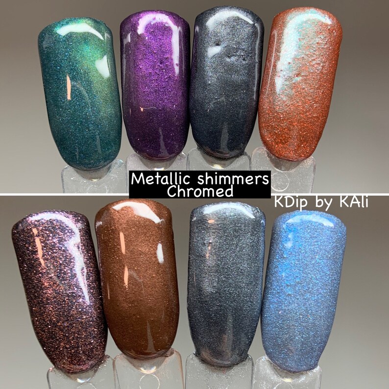May include: A collection of eight nail polish swatches in various metallic shimmer shades. Colors include teal, purple, charcoal, copper, and blue. The text "Metallic shimmers Chromed" and "KDip by KAli" are visible.