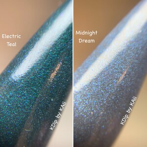 May include: Close-up of two nail polish samples. One is a teal color labeled "Electric Teal", the other is a dark blue-gray color labeled "Midnight Dream". Both have a glittery, iridescent finish. The text "KDip by KAli" is visible.