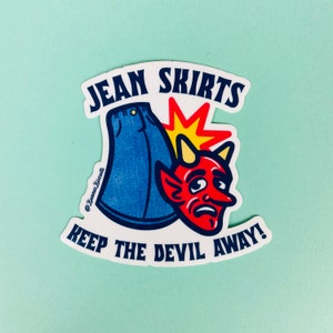 May include: A white sticker with a blue jean skirt, a red devil with horns, and a yellow explosion. The text reads "Jean Skirts Keep the Devil Away!" and "@Bunny Biscuits".