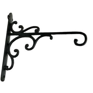 May include: Black cast iron hanging bracket with decorative scrollwork. The bracket features a vertical mounting plate, a horizontal arm, and ornate curved details. Perfect for hanging plants or signs.