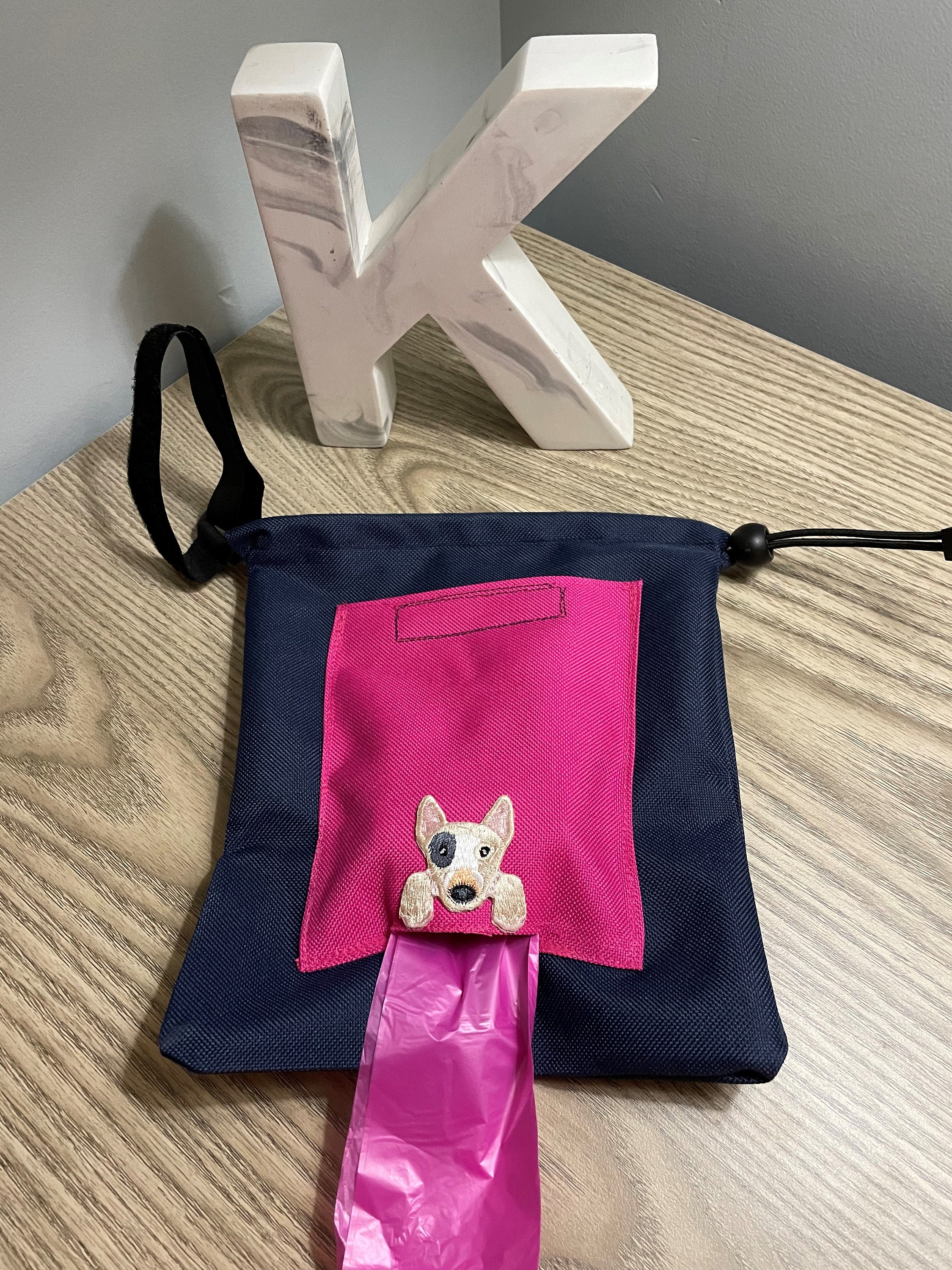 Dog waste carrier and disposable bag all in one. Attaches to Etsy