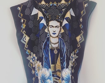 May include: A black hooded poncho with a colorful pattern featuring a portrait of Frida Kahlo. The pattern includes geometric shapes, flowers, and a blue and gold background.