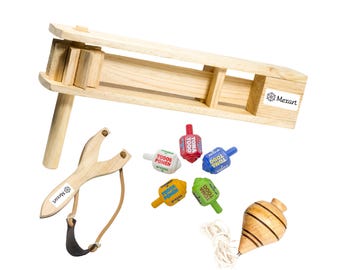 May include: A collection of traditional wooden toys, including a ratchet, slingshot, and spinning tops. The toys are made of natural wood and feature colorful accents. The image includes the Mexart logo.