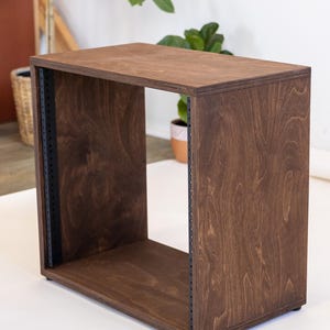 May include: A dark brown wooden rack with black metal rails. The rack is empty and has a smooth, finished surface.