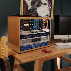 May include: A wooden rack case containing various audio equipment modules, including a Radial unit, a Cloudlifter CL-4 mic activator, a QSC power amplifier, and an Effectron II unit, all mounted in a vertical stack on a wooden desk surface.