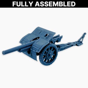 May include: A fully assembled, blue model cannon with a long barrel, spoked wheel, and detailed carriage. The text "FULLY ASSEMBLED" is displayed in white at the top of the image. This miniature replica is likely for collectors or hobbyists.