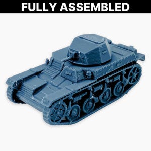 May include: A blue model tank with a turret and treads. The words "FULLY ASSEMBLED" are printed in white at the top of the image. The tank is a miniature replica of a military vehicle.