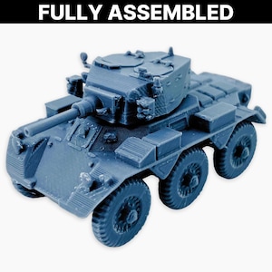 May include: A fully assembled, blue-gray model of an armored vehicle. The model features a turret, a long gun barrel, and six wheels. The text "FULLY ASSEMBLED" is displayed in white at the top of the image. This model is likely a collectible or a toy.