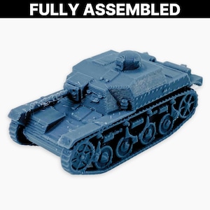 May include: A blue model tank with track wheels and a turret. The text "FULLY ASSEMBLED" is printed in white at the top of the image. The tank is a detailed miniature replica.