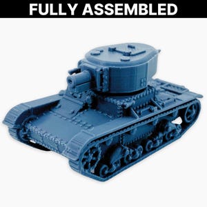 May include: A blue model tank, fully assembled, featuring intricate track detailing, a turret, and a gun. The text "FULLY ASSEMBLED" is visible above. This miniature replica is likely for collectors or hobbyists.