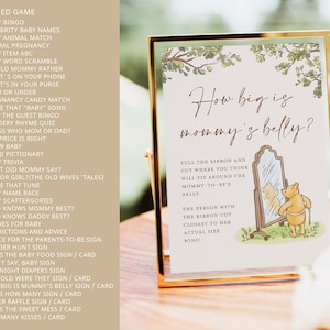 May include: A Winnie the Pooh-themed baby shower game card with a pink background and a gold frame. The card features a cartoon illustration of Winnie the Pooh looking in a mirror. The text on the card reads "How big is mommy's belly?" and includes instructions for a game where guests guess the size of the expectant mother's belly.