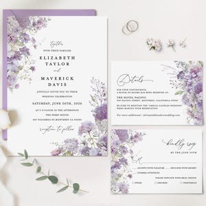 May include: A wedding stationery set with a floral watercolour design in purple and lavender hues. The invitation includes the names Elizabeth Taylor and Maverick Davis, the wedding date, time, and location. RSVP and details cards are also included.