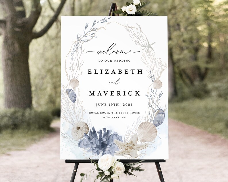 May include: A white wedding welcome sign with a watercolor illustration of seashells, starfish, and seaweed. The sign reads "Welcome to our wedding, Elizabeth and Maverick, June 19th, 2026, Royal Room, The Perry House, Monterey, CA."