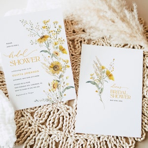 May include: Two bridal shower invitations with a watercolor floral design featuring yellow flowers and green leaves. The text on the invitations reads "bridal shower" and includes the bride-to-be's name, date, time, and location.