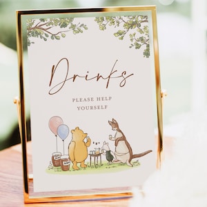 May include: A Winnie the Pooh themed drinks sign with a gold frame. The sign says "Drinks" and "Please Help Yourself". The image features Winnie the Pooh, Piglet, and Kanga enjoying a picnic.
