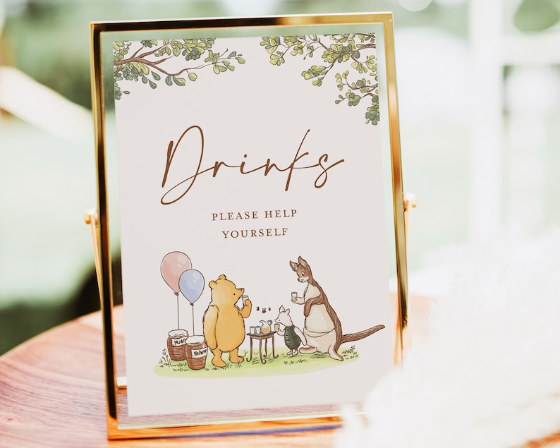 May include: A Winnie the Pooh themed drinks sign with a gold frame. The sign says "Drinks" and "Please Help Yourself". The image features Winnie the Pooh, Piglet, and Kanga enjoying a picnic.