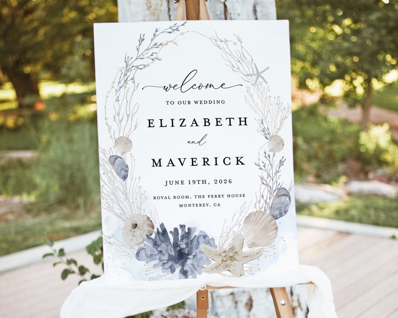 May include: A white wedding welcome sign with a watercolor illustration of seashells, starfish, and seaweed. The text reads "welcome to our wedding Elizabeth and Maverick June 19th, 2026 Royal Room, The Perry House Monterey, CA"