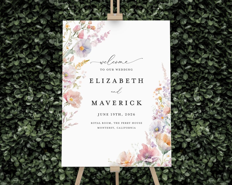 May include: A wedding welcome sign with a floral design in shades of pink, purple, and yellow. The sign reads "Welcome to our wedding, Elizabeth and Maverick, June 19th, 2026, Royal Room, The Perry House, Monterey, California."