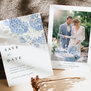 May include: Two wedding announcement cards. One features blue hydrangea flowers and the text "Save the Date." The other shows a couple cutting a cake. Both cards include the names Olivia & Theodore and the date.
