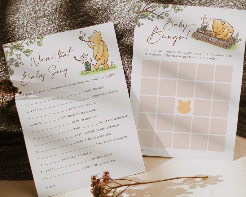 May include: Two printable baby shower game cards featuring Winnie the Pooh and Piglet. The first card is a "Name That Baby Song" game with a list of songs that include the word "baby". The second card is a "Baby Bingo" game with a grid of squares to be filled with gifts the mother-to-be will receive.