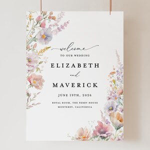May include: A wedding welcome sign with watercolor floral designs in shades of pink, purple, and green. The text reads "Welcome to our wedding, Elizabeth and Maverick, June 19th, 2026, Royal Room, The Perry House, Monterey, California."