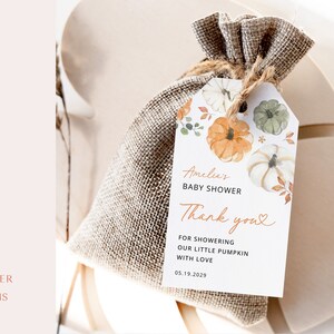 May include: A white thank you tag with watercolor illustrations of pumpkins and fall leaves. The tag says "Amelia's Baby Shower Thank you" and includes the date "05.19.2029".