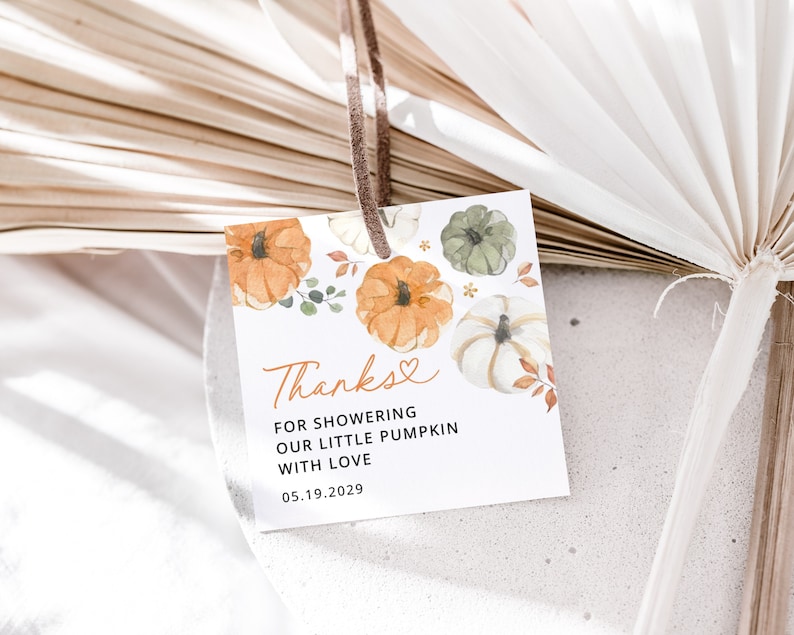 May include: A white thank you tag with a watercolor illustration of pumpkins and leaves. The text reads "Thanks for showering our little pumpkin with love 05.19.2029".