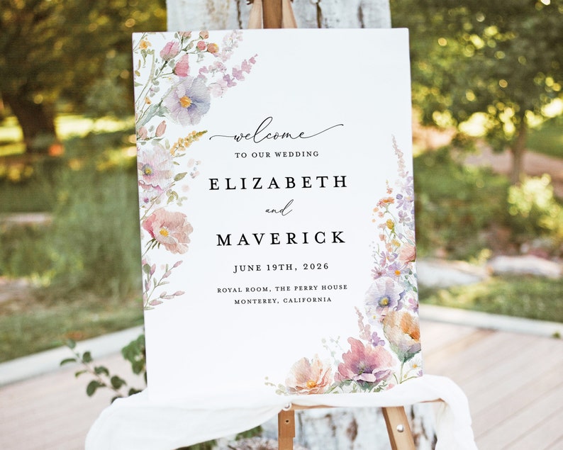 May include: A wedding welcome sign with watercolor floral designs in shades of pink, purple, and green. The sign reads "Welcome to our wedding, Elizabeth and Maverick, June 19th, 2026, Royal Room, The Perry House, Monterey, California."