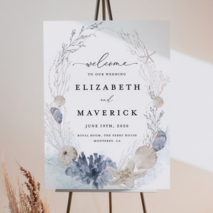 May include: A watercolor wedding welcome sign with a blue and white seashell and starfish design. The sign reads "Welcome to our wedding, Elizabeth and Maverick, June 19th, 2026, Royal Room, The Perry House, Monterey, CA."
